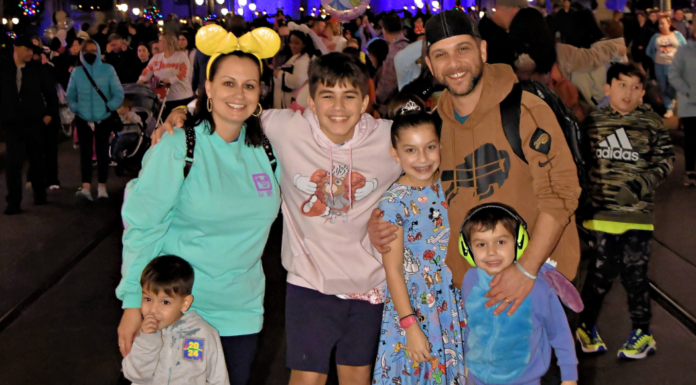 A family posing for a photo at Disney World.