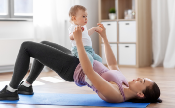 A mother exercising with her baby.