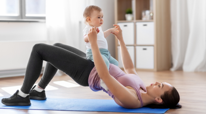 A mother exercising with her baby.