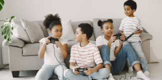 Siblings playing video games together.