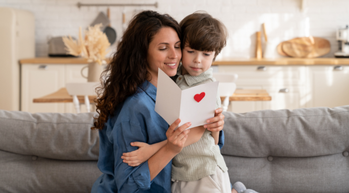A mom reading a Mother's Day card.