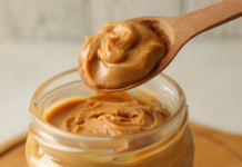 A spoon full of peanut butter.