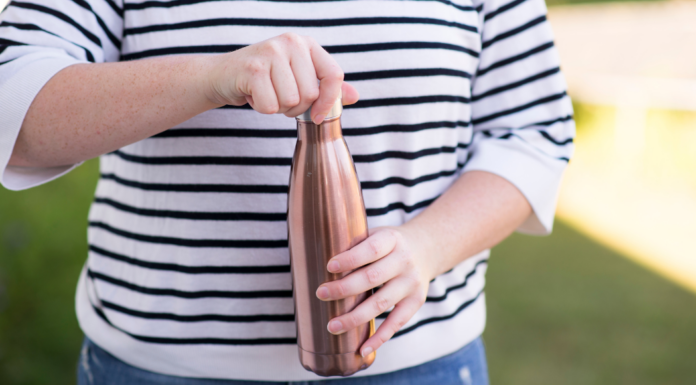 A woman holding a water bottle.