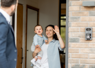 A mother and baby waving goodbye to the father.