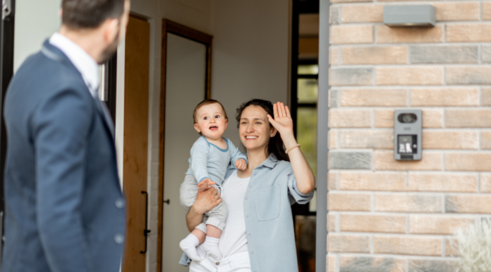 A mother and baby waving goodbye to the father.