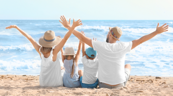 A family sitting together on a beach.