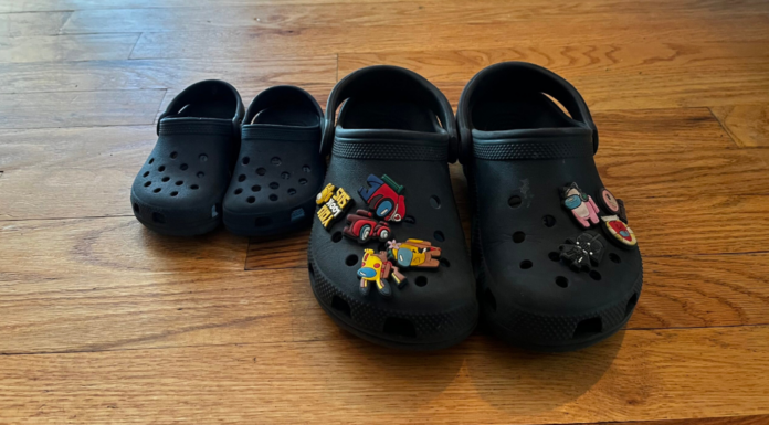 Double Digits Two pairs of black crocs.