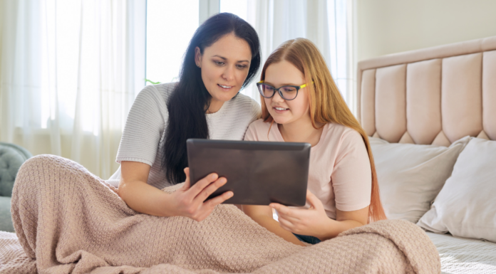 A mom and her tween looking at a tablet.