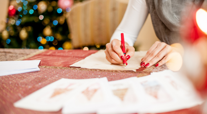 A woman addressing holiday cards.