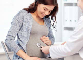 A woman getting an exam while pregnant.