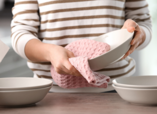 Drying dishes with a dish towel.