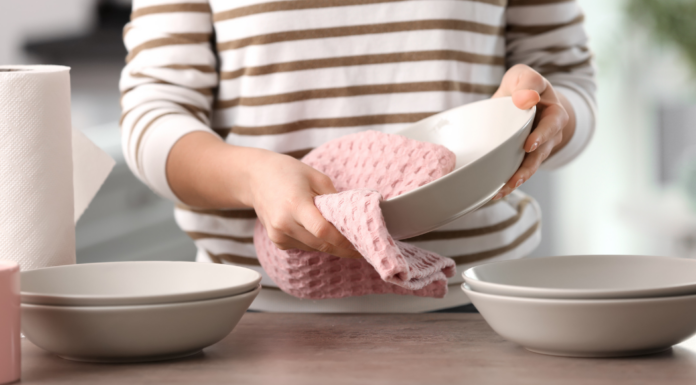 Drying dishes with a dish towel.
