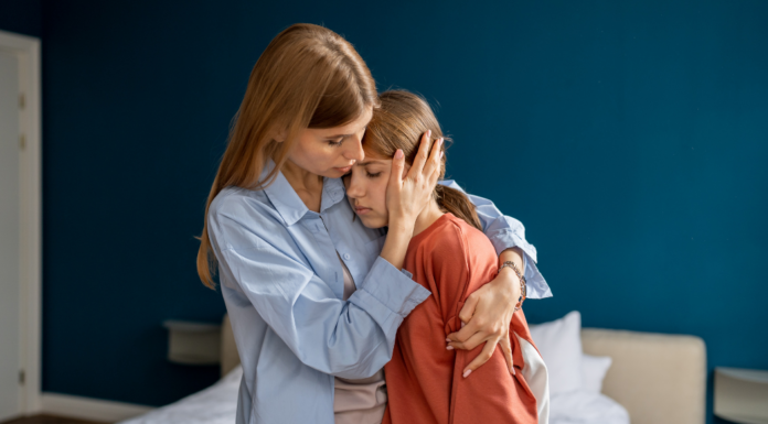 A mom comforting her daughter.