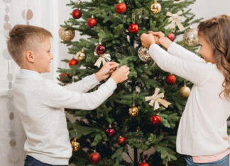 Kids decorating a Christmas tree.