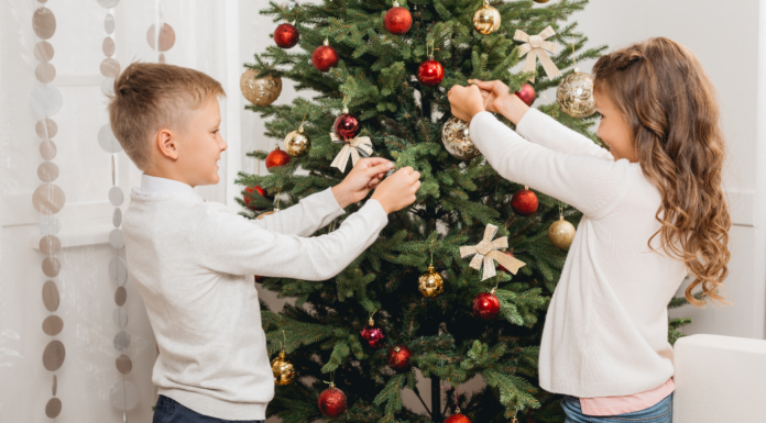 Kids decorating a Christmas tree.