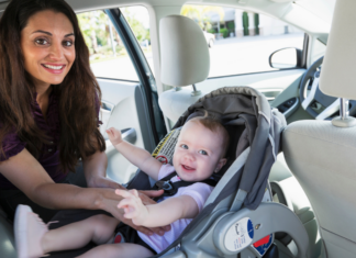 Safety First: Car Seats and Staying Rear-Facing A mother getting her child out of a rear-facing car seat.