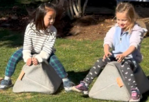 Girls pretending to ride horses.