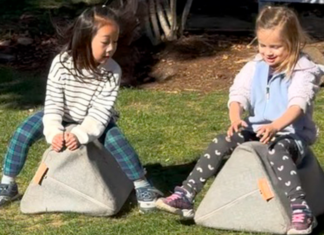 Girls pretending to ride horses.