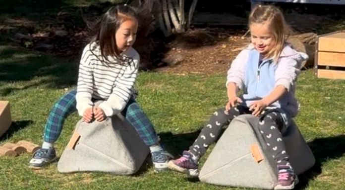 Girls pretending to ride horses.