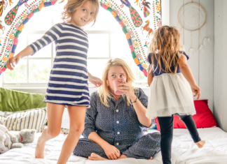 A stressed mom drinking coffee while parenting.
