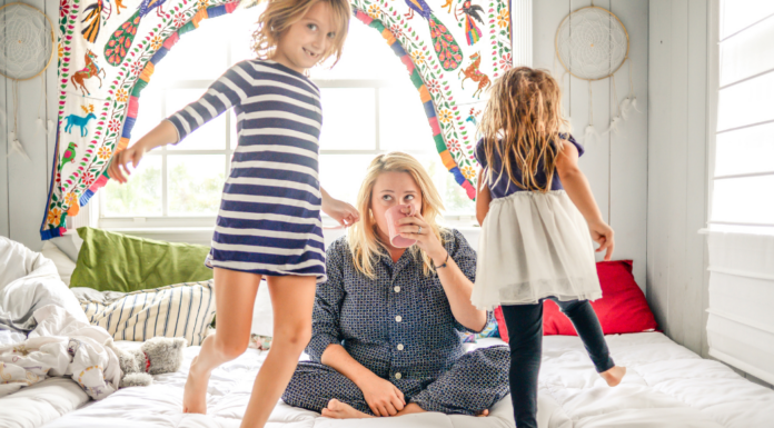 A stressed mom drinking coffee while parenting.