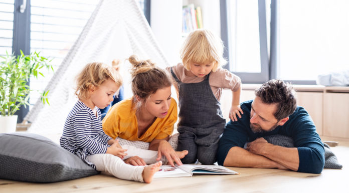 Building a Baby’s Library: My Favorite Children’s Books A family reading a children's book.