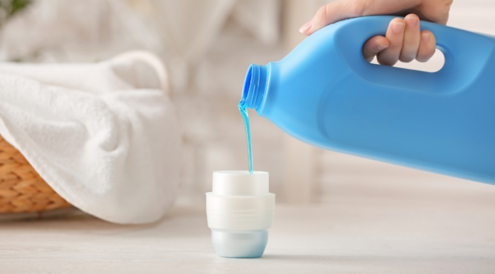 Pouring laundry detergent.