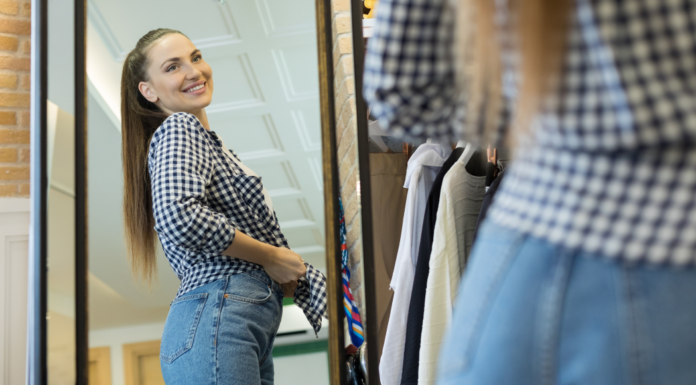 A woman trying on her pre-baby wardrobe.