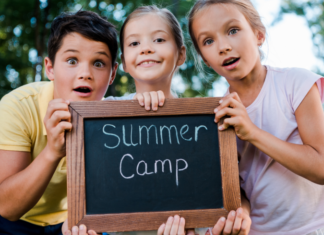 2026 Guide to Summer Camps In & Around Fairfield County Kids holding a summer camp sign.