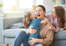 Children climbing on their mother.