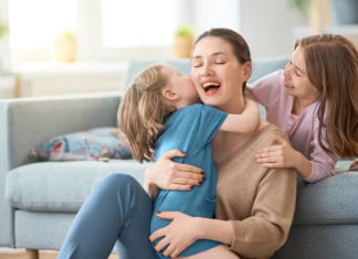 Children climbing on their mother.
