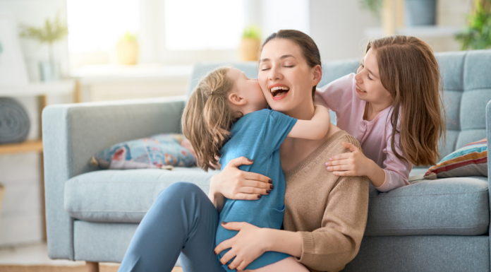 Children climbing on their mother.