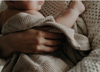 A mother holding a newborn.