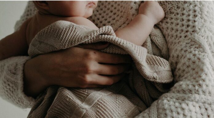 Dear Momma, Where Did Time Take You? A mother holding a newborn.