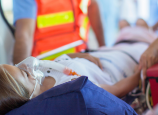 A woman going in an ambulance.