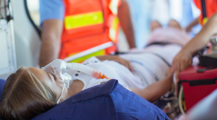 A woman going in an ambulance.