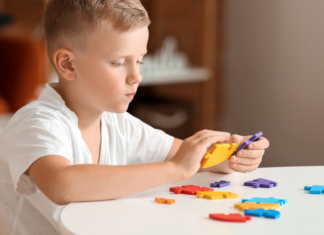 A boy doing a puzzle.