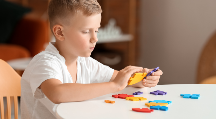 A boy doing a puzzle.