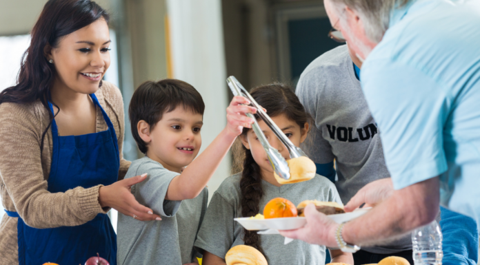 Kids helping to serve at a soup kitchen.