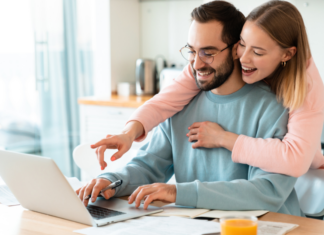 Ten Years of Marriage: Love, Laughter, and Noise Ordinances A woman hugging her husband while he's on the computer.