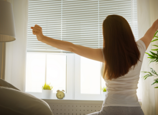 A woman getting out of bed early.