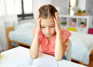 An anxious girl holding her head.