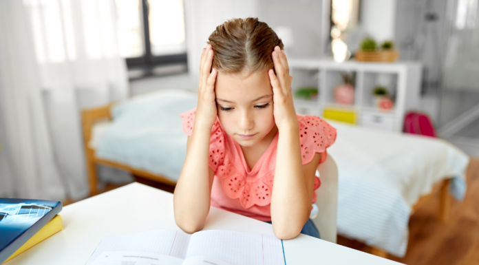 An anxious girl holding her head.