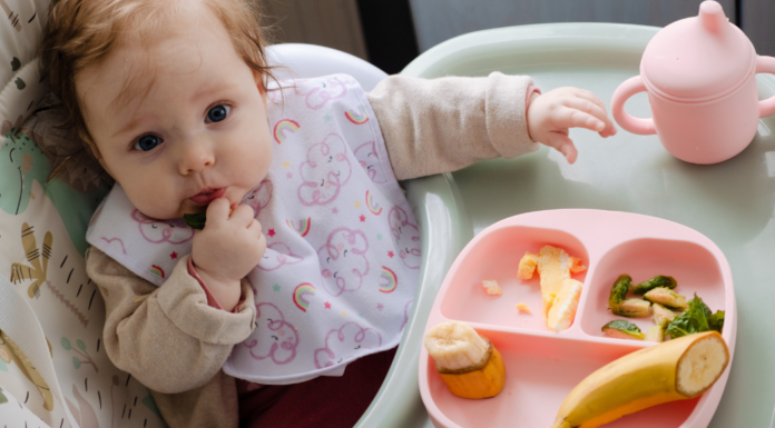 A baby eating food.