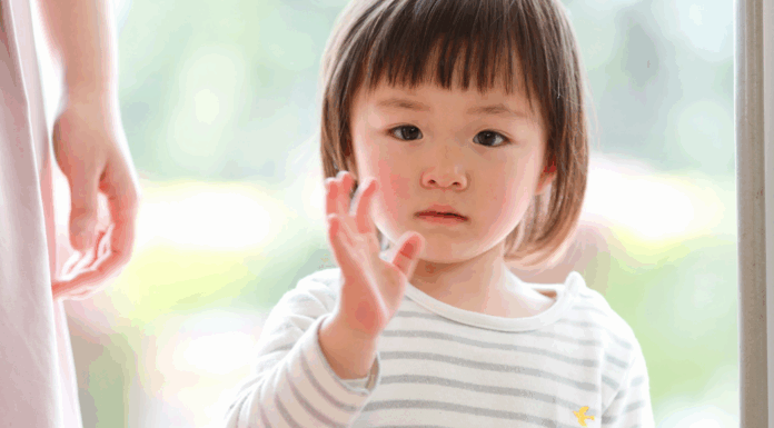 A girl waving goodbye.