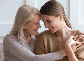 A mom hugging her adult daughter.