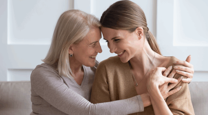 A mom hugging her adult daughter.