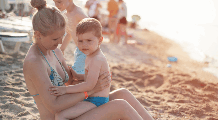 Only 18 Summers? A mother holding her son at the beach.