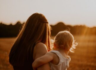 A mother holding her baby.