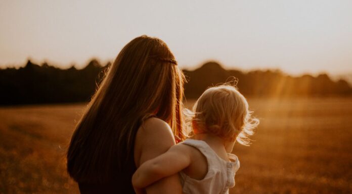 A mother holding her baby.